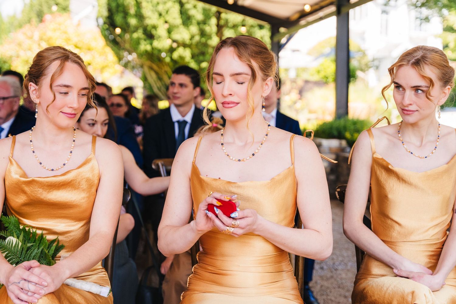 Poulaphouca Wedding photographer wicklow  Wedding party in gold satin dresses posed outdoors on a sunny day.