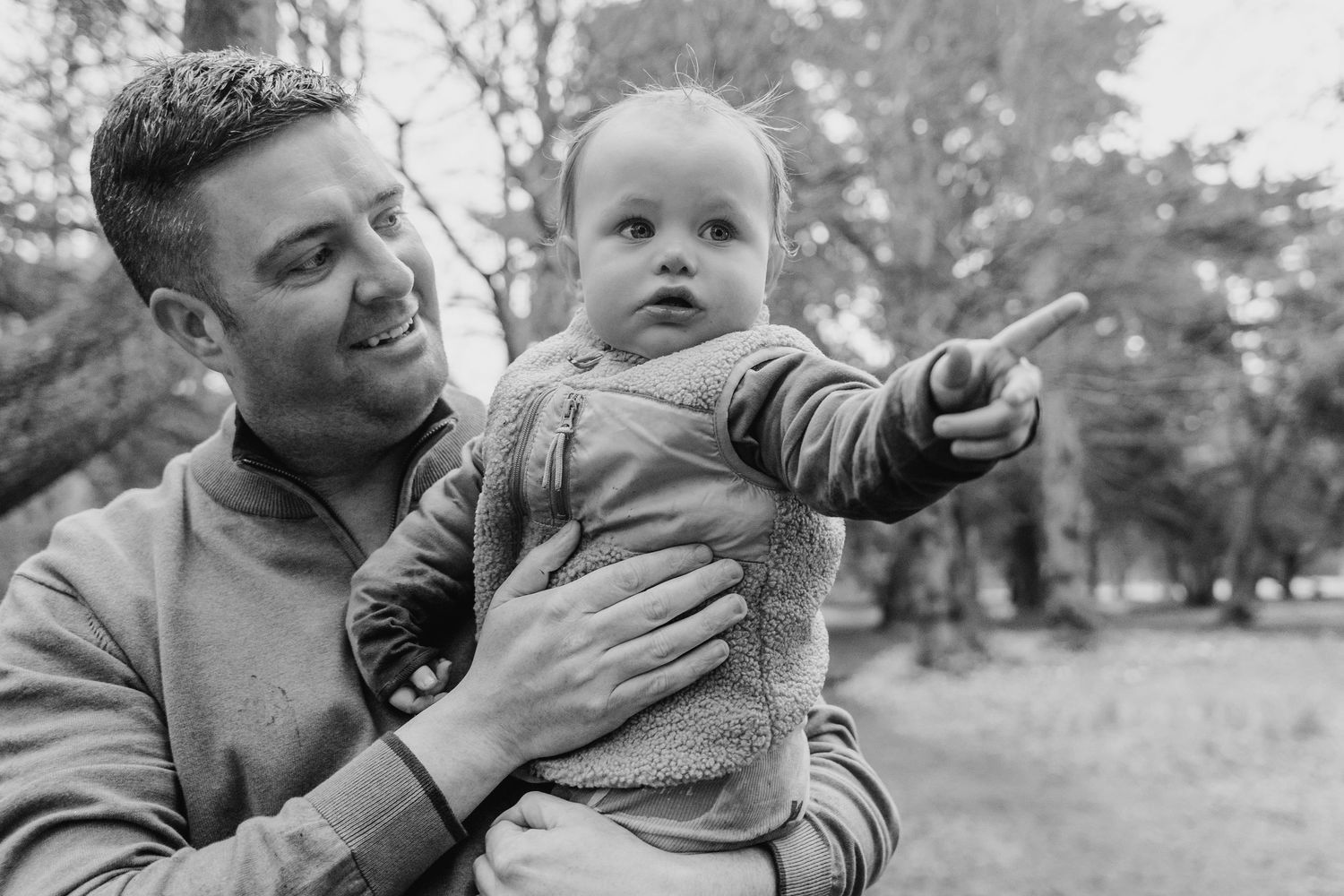 Black and white photo montage showing close interactions between an adult and baby in an outdoor setting. Family photographer Dublin Ireland