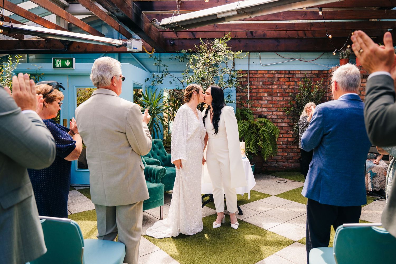 Wedding party members in white outfits and formal attire celebrating together at an event. House Dublin Wedding Photographer