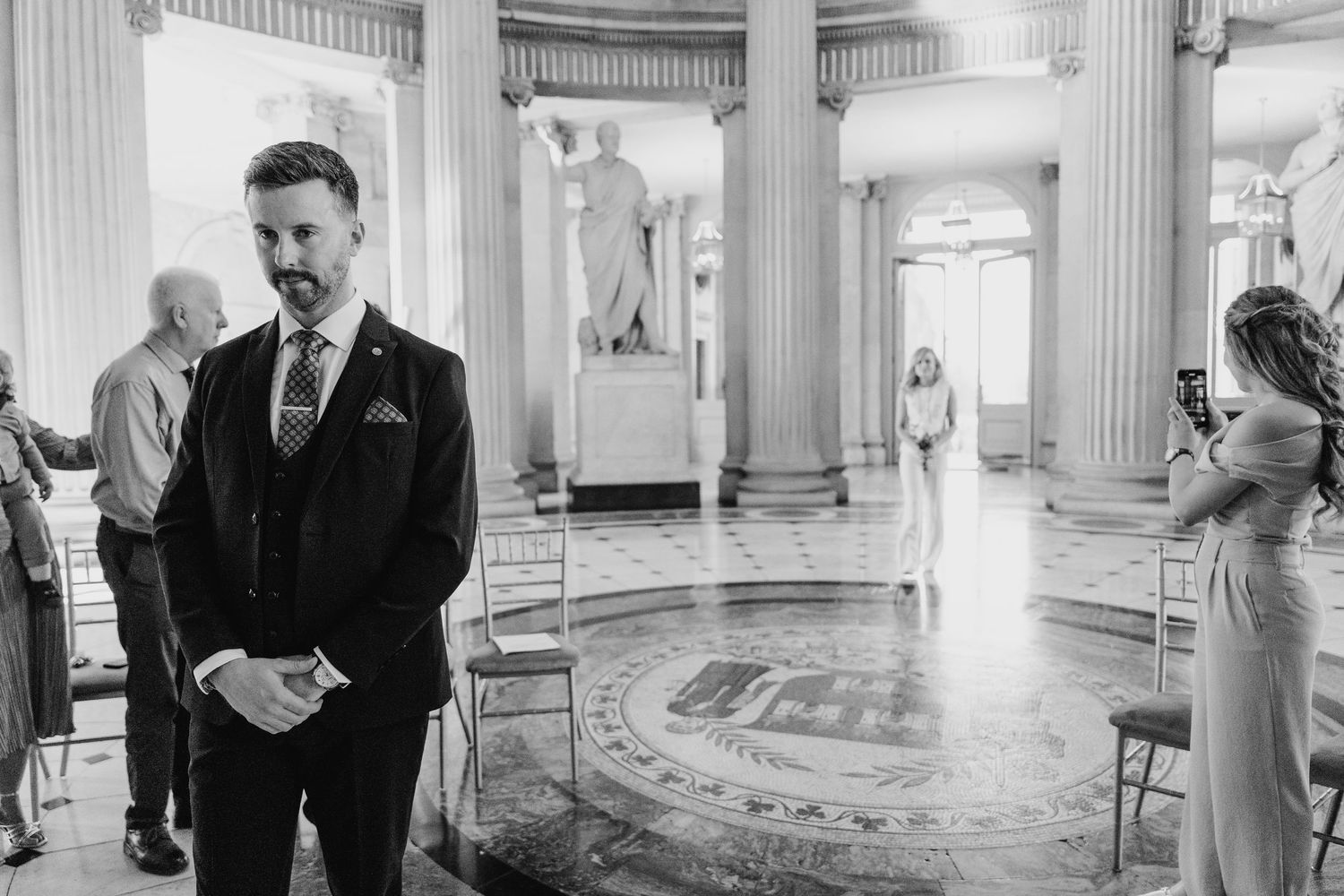Elegant classical interior with white columns and marble floors in historic Dublin building. City Hall Dublin wedding photogrAPher