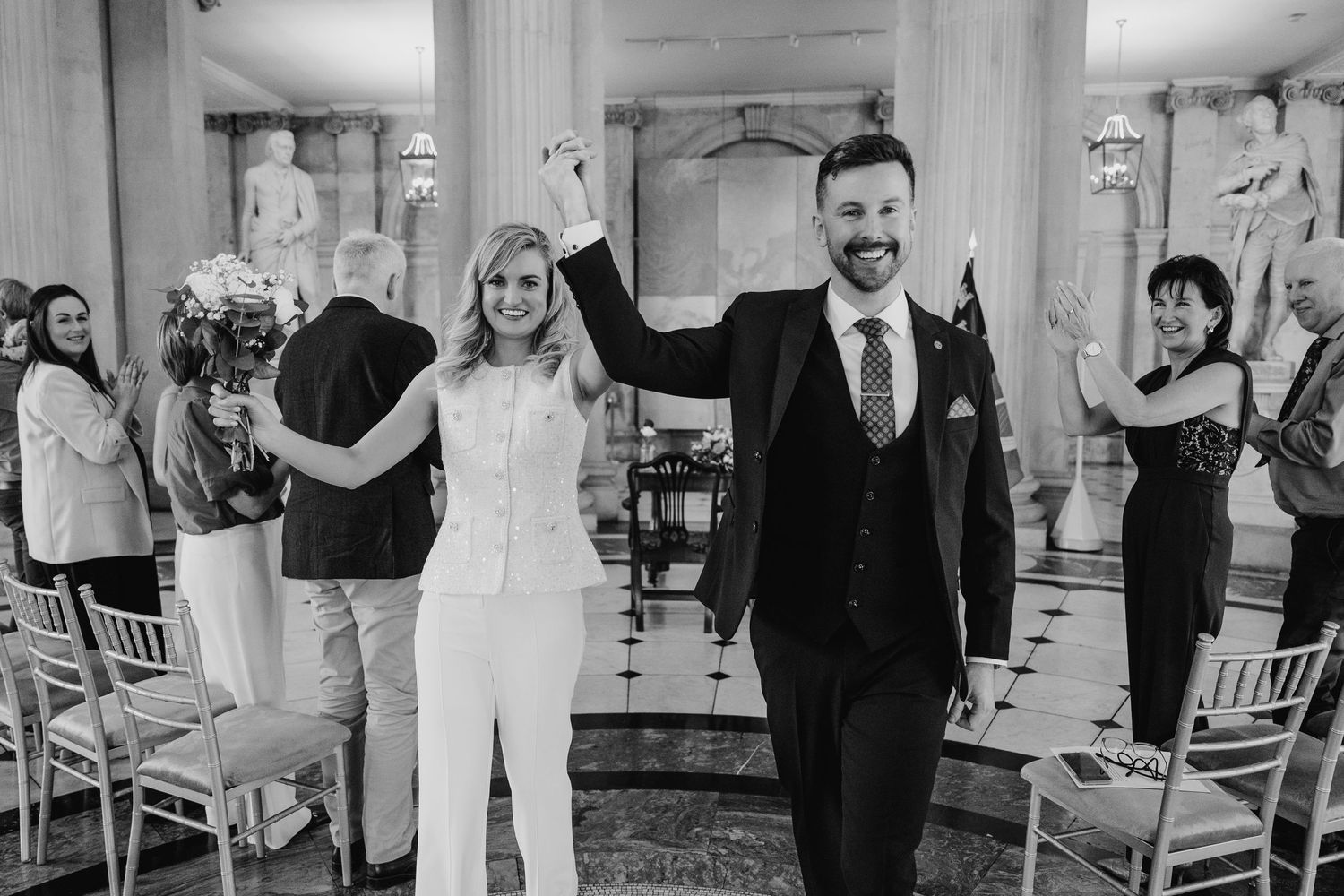 Black and white photographs of a wedding celebration with elegant decor and seating arrangements. City Hall Dublin wedding photogrAPher