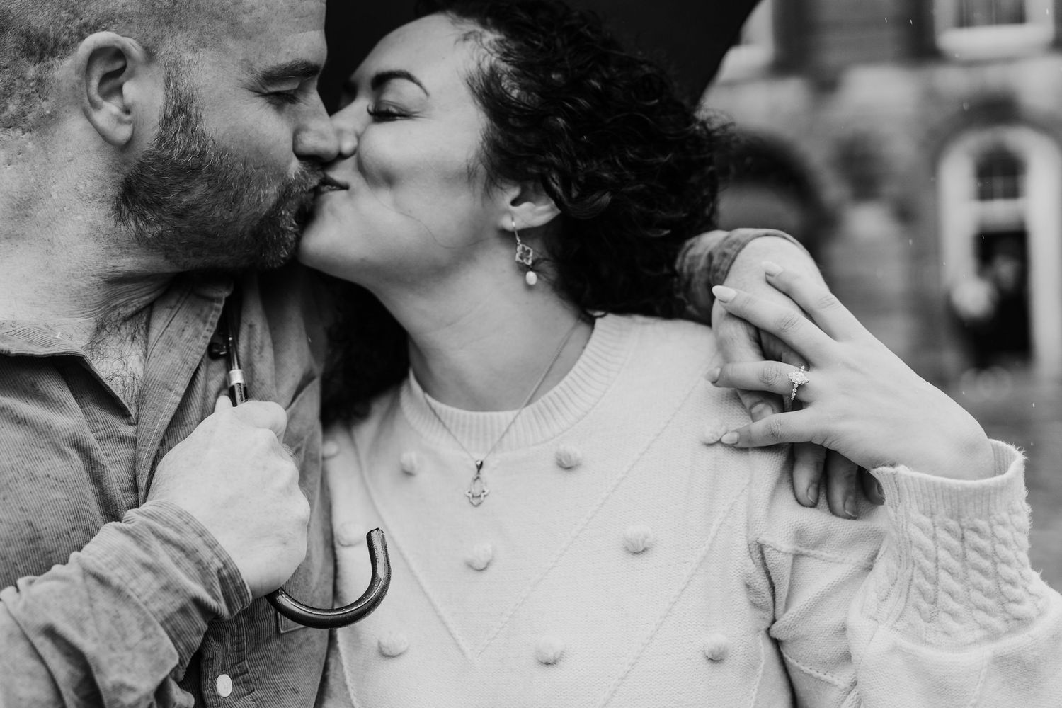 A black and white photo series showing a romantic couple in tender embraces and kisses in different poses. Proposal Dublin Photographer
