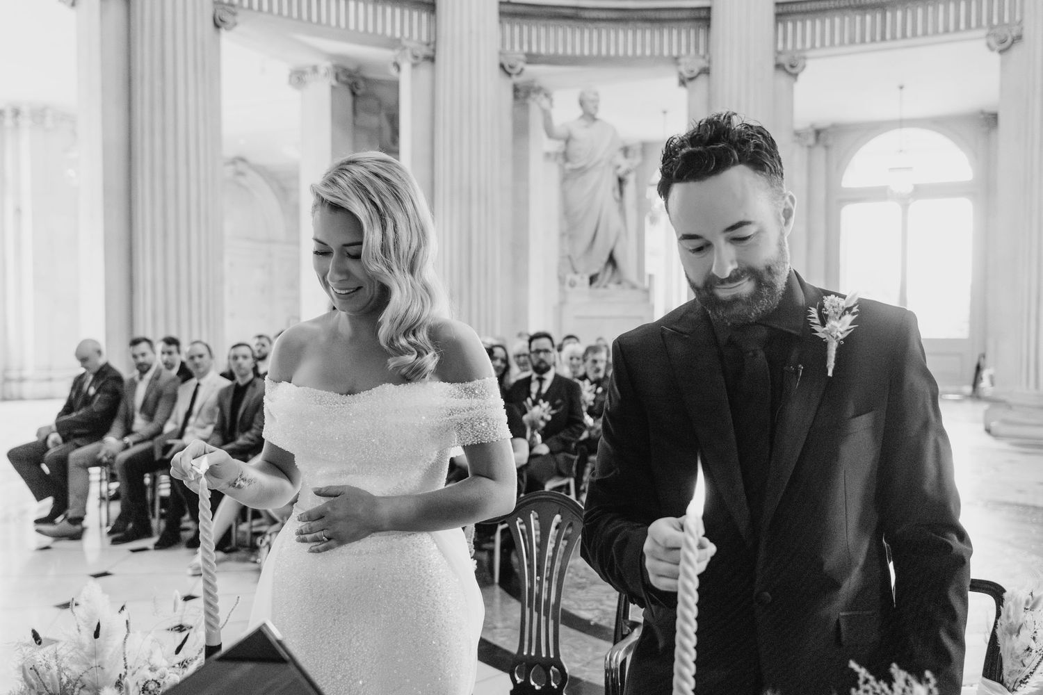 Elegant wedding ceremony space with classical white columns and natural light streaming through windows.  city hall dublin wedding photos