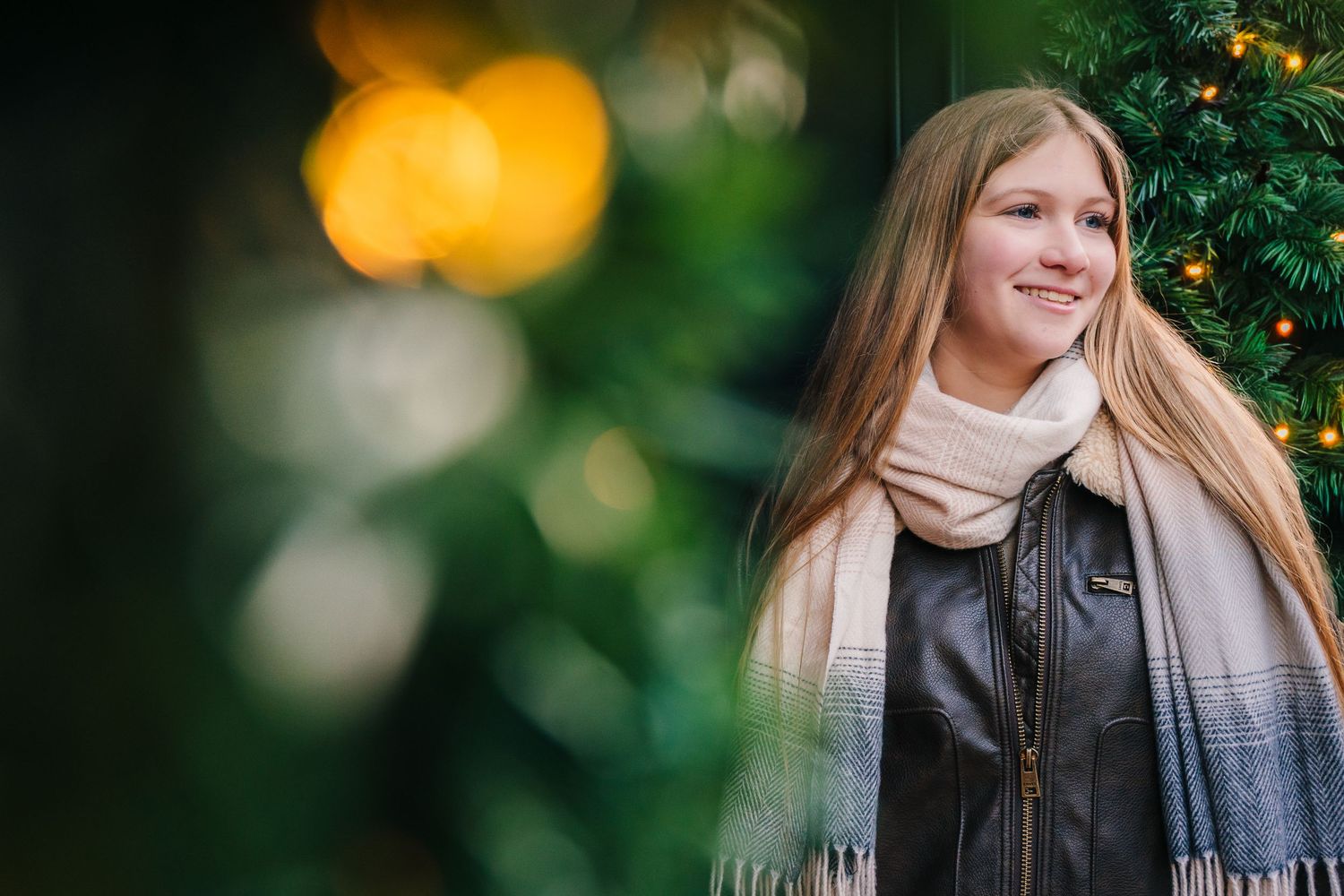 Romantic portrait with soft bokeh lights and greenery in background. family PHOTOGRAPHER Dublin