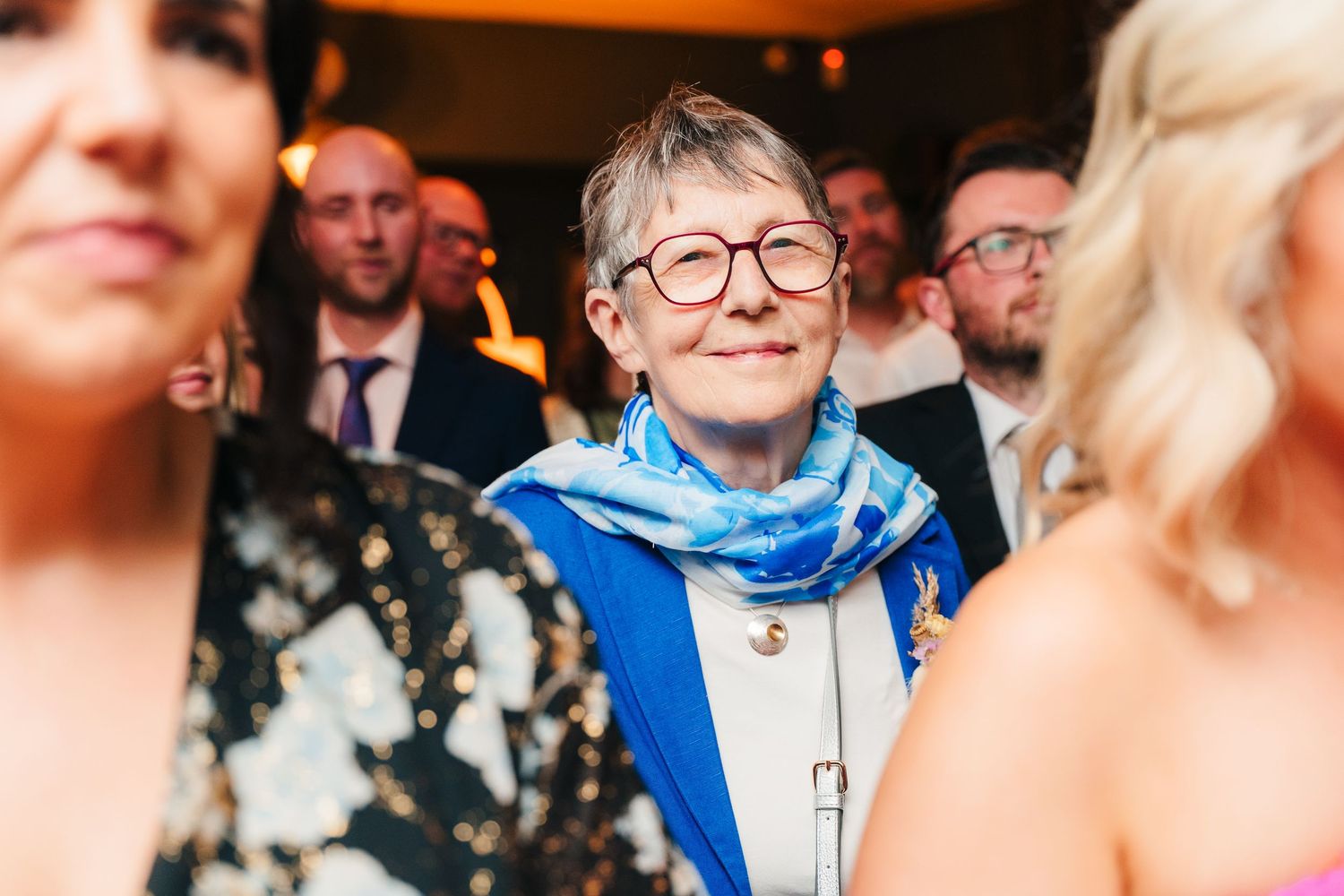 Guests mingling and socializing at an indoor event with blue lighting. Marco Pierre Dublin Wedding Photographer