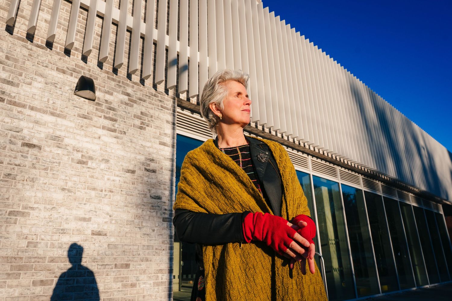 A person wearing a mustard yellow jacket and red shirt. professional headshots branding photographer dublin ireland