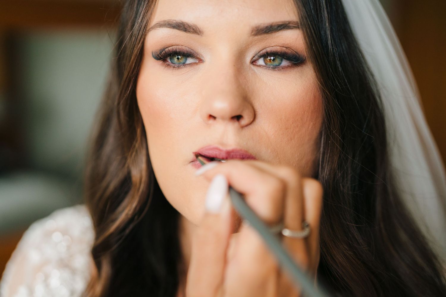 Close up shot of someone having makeup applied with a brush before a wedding ceremony. Portmarnock Hotel Wedding PHOTOGRAPHER Dublin