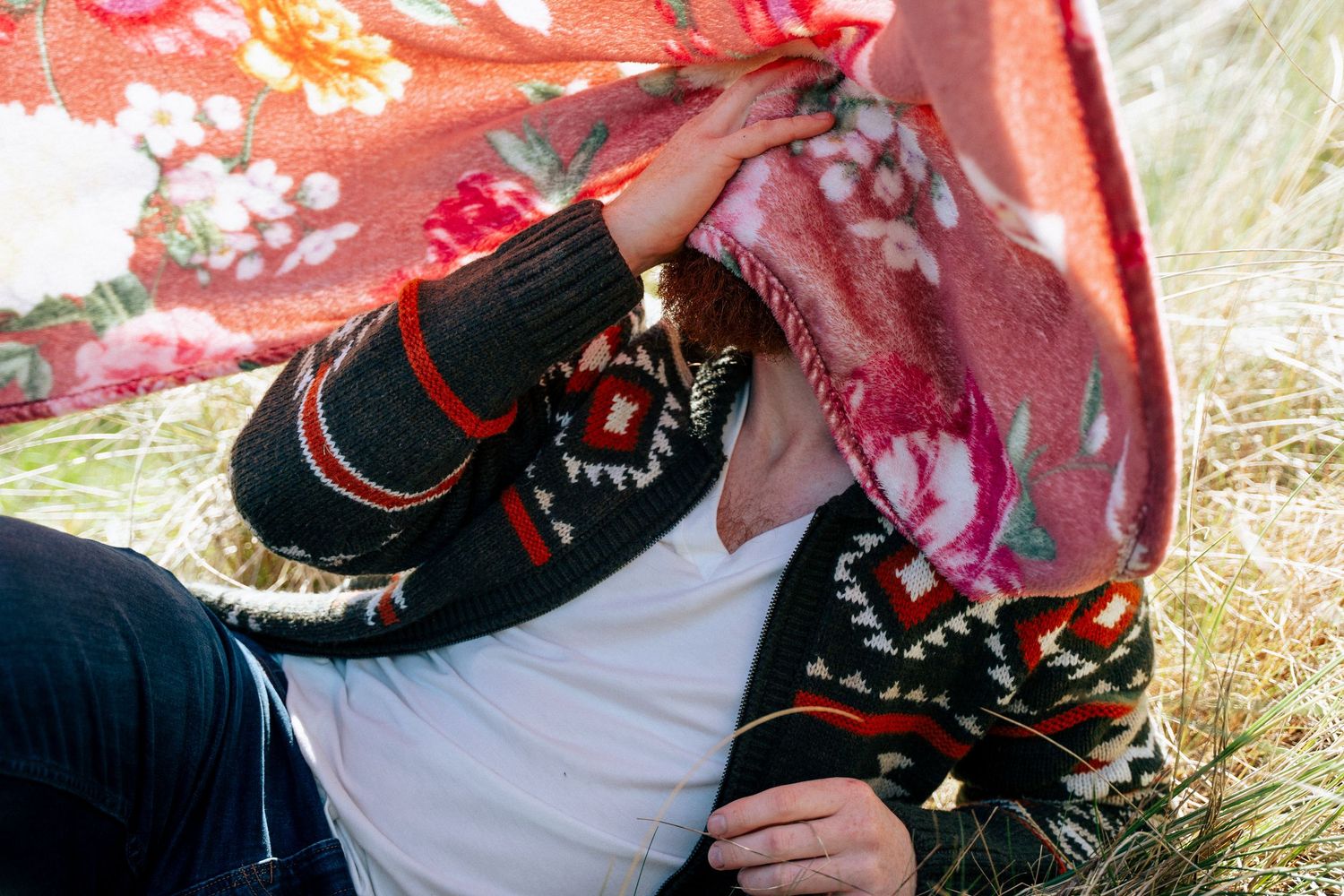 Close-up shot of black shoes and floral print clothing against a red background. PHOTOGRAPHER Dublin
