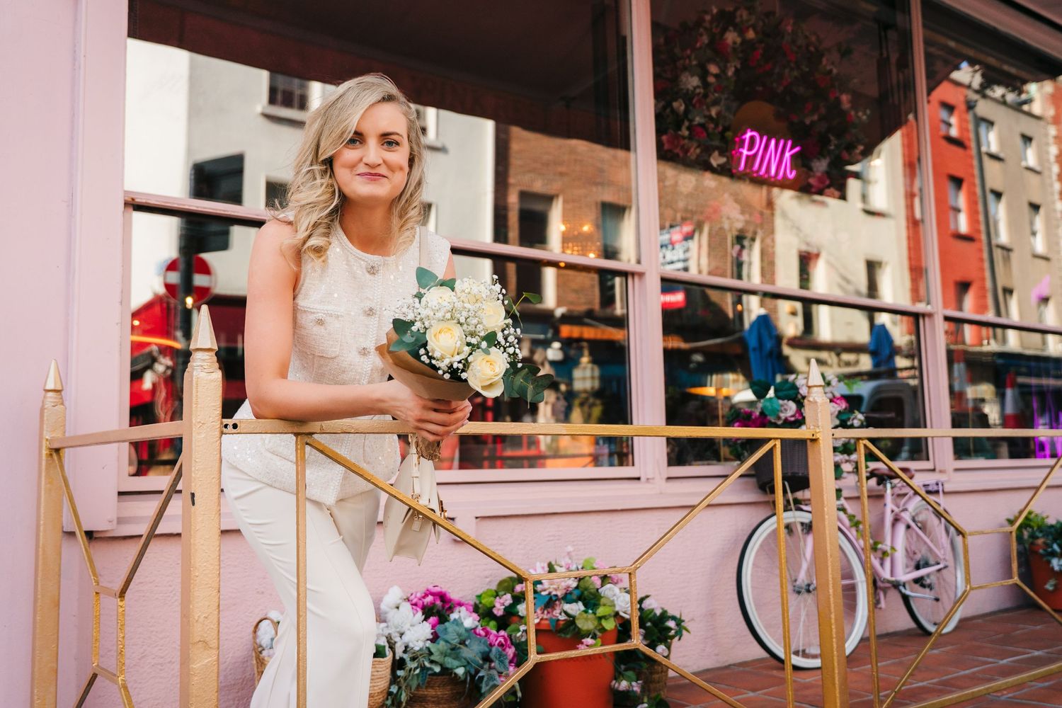 Outdoor city scene with pink awning and decorative railings. City Hall Dublin wedding photogrAPher