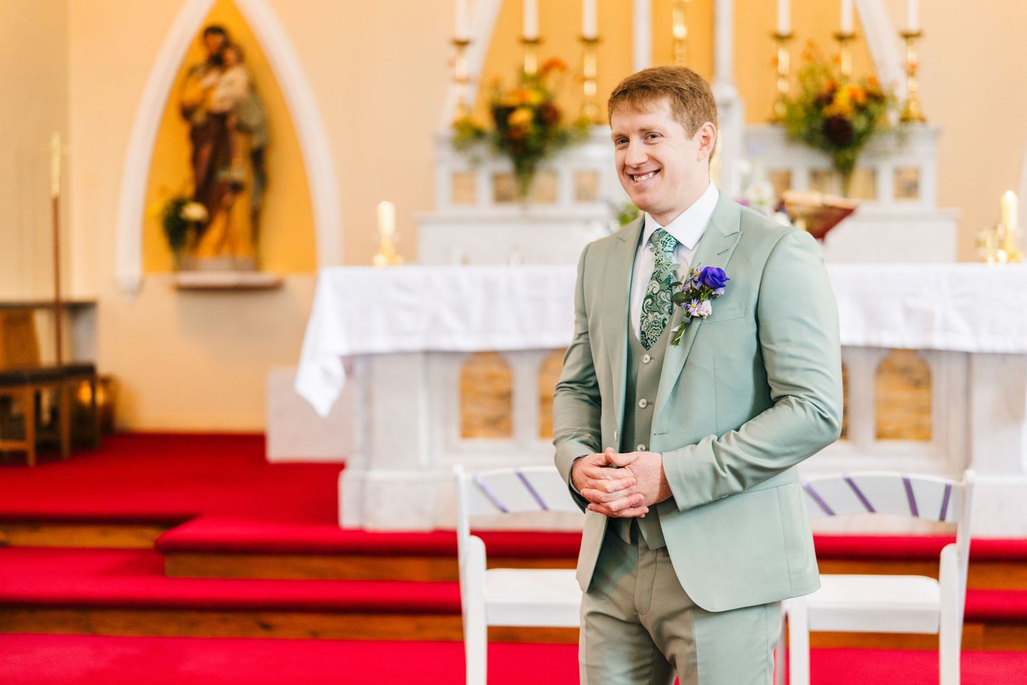 Millhouse slane wedding photographeHappy couple sharing joyful moments inside a church with elegant interior decor and floral arrangements.