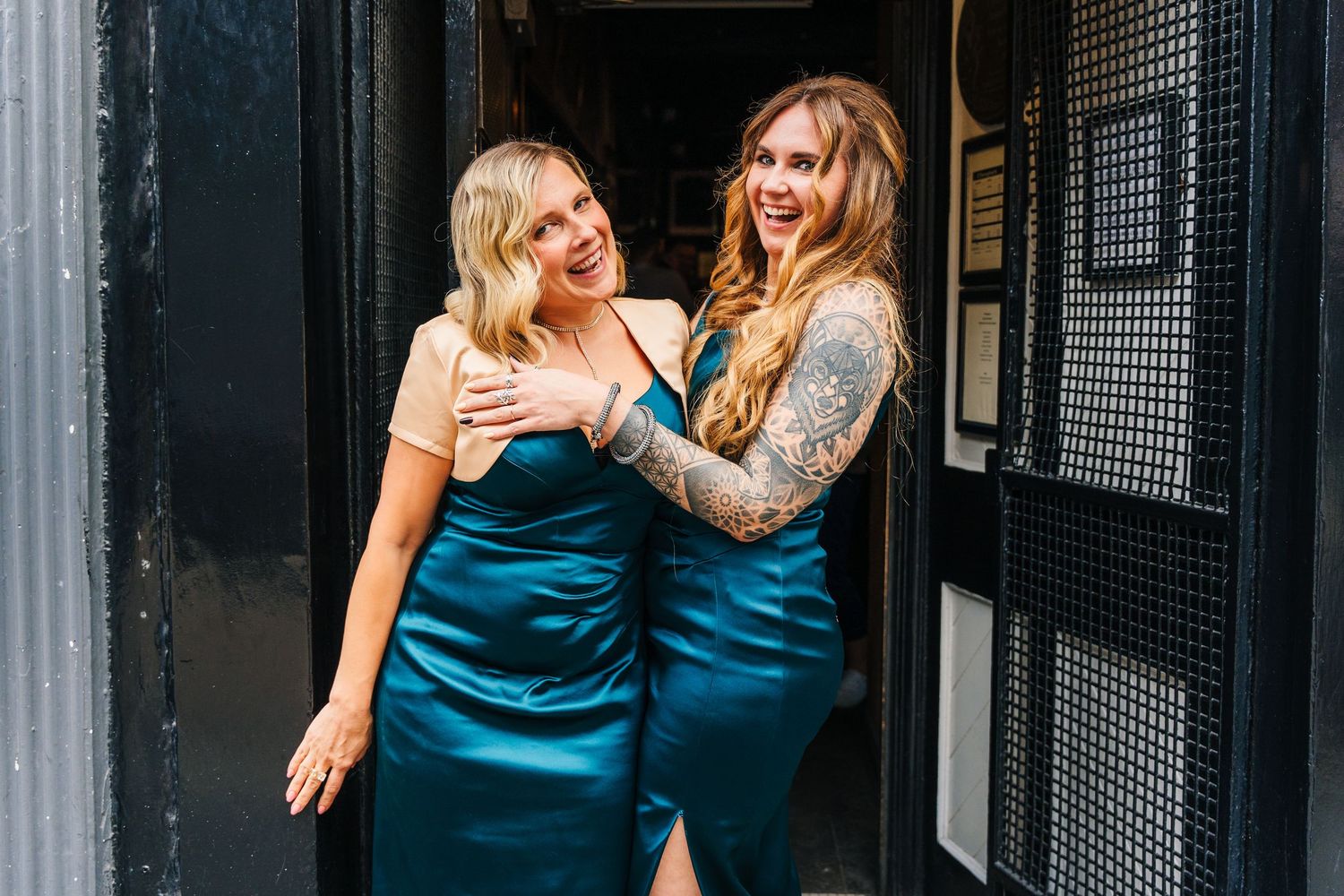 Group of wedding attendees in teal dresses gather in an urban setting. House Dublin Wedding Photographer