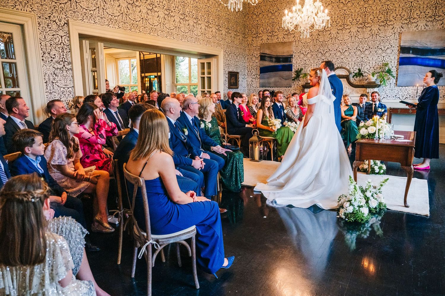 Panoramic view of an elegant wedding venue with crystal chandelier and ornate wallpaper.  Virginia Park Lodge Wedding Photographer Cavan Dub