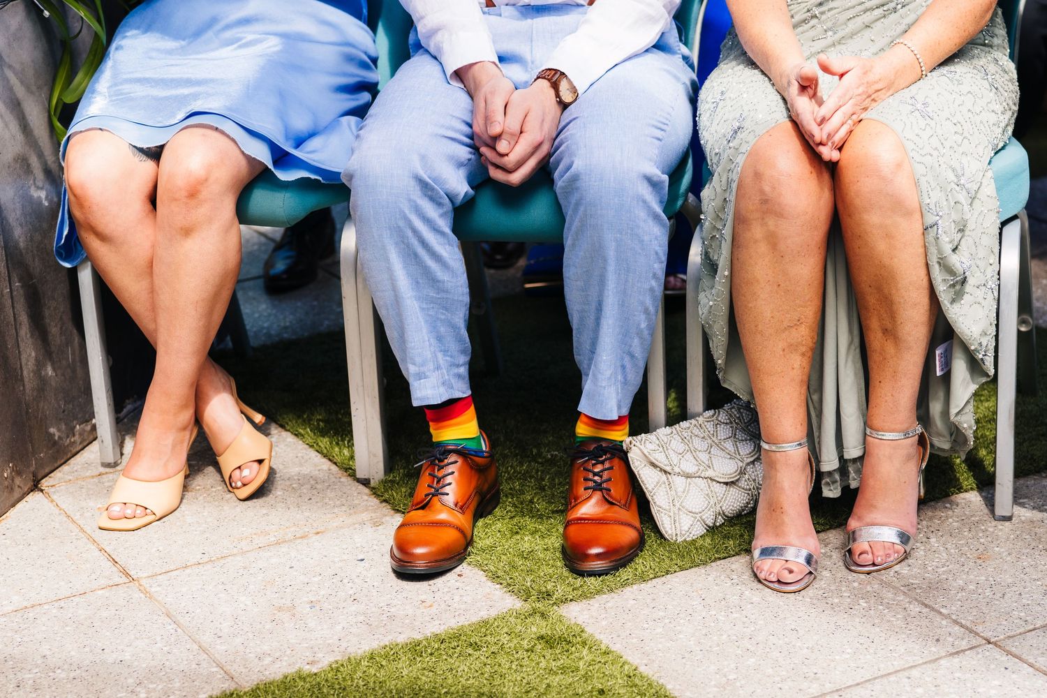 Close-up shot of three people's legs and feet showing contrasting formal footwear styles at an event. House Dublin Wedding Photographer