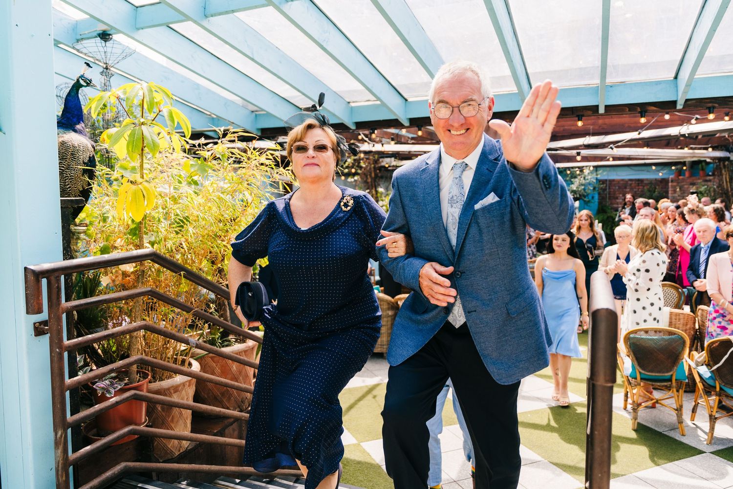 Outdoor celebration under a glass-roofed venue with guests mingling in formal attire. House Dublin Wedding Photographer