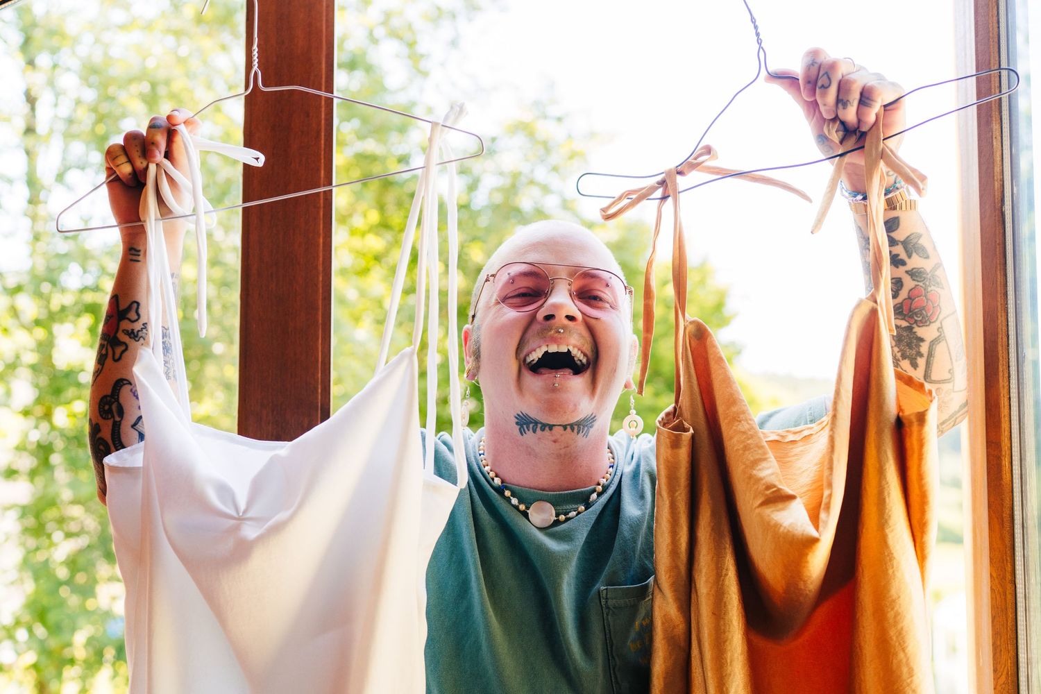 Poulaphouca Wedding photographer wicklow Bridesmaids in colorful dresses celebrating joyfully near sunlit windows.