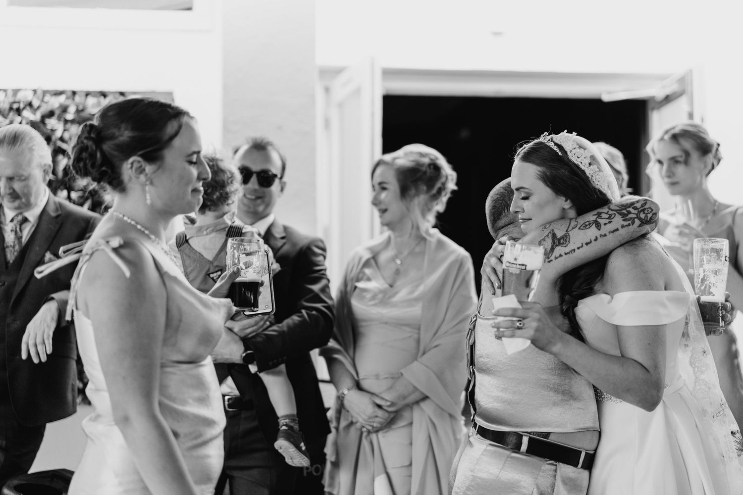 Poulaphouca Wedding photographer wicklow  Candid black and white wedding moments showing guests enjoying themselves at an indoor reception.