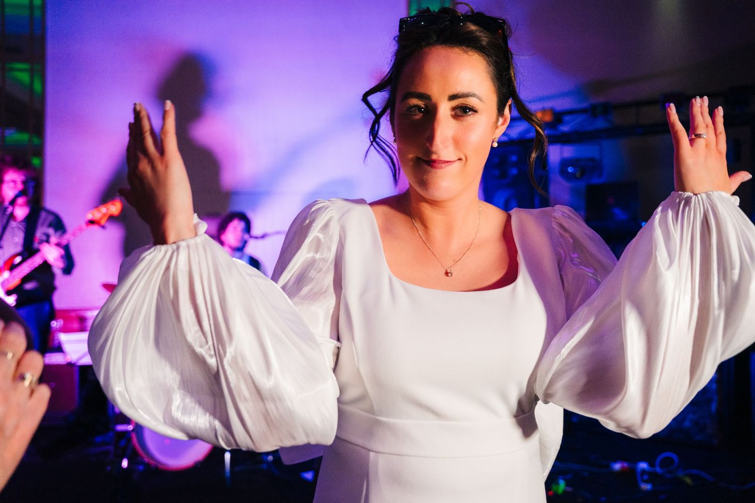 Wedding dance party with purple lighting and guests dancing with raised arms.Wedding Photography Trim Castle Ireland