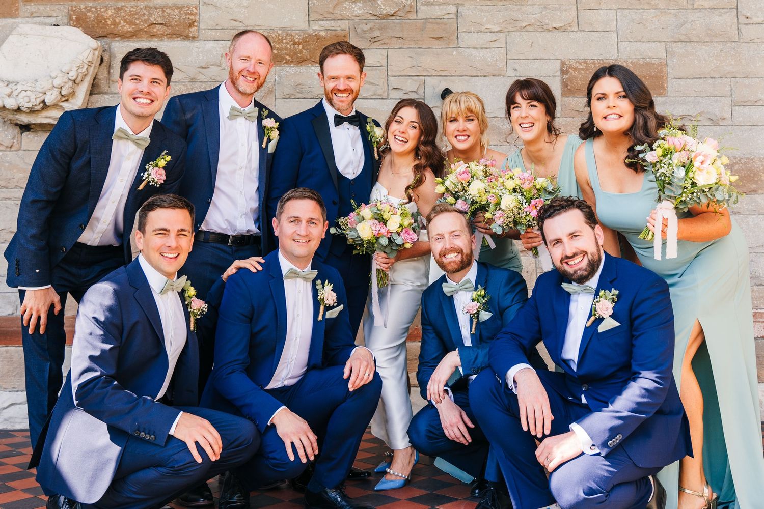 Castle Leslie Wedding Photographer Dublin Wedding party in navy blue suits and formal attire posing together outdoors.