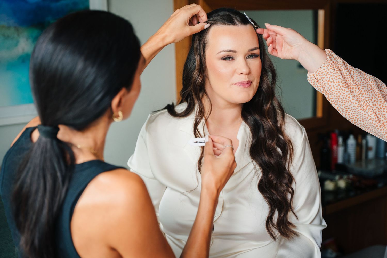 Wedding makeup artist carefully applies cosmetics to client while preparing for special occasion. Portmarnock Hotel Wedding PHOTOGRAPHER Dub