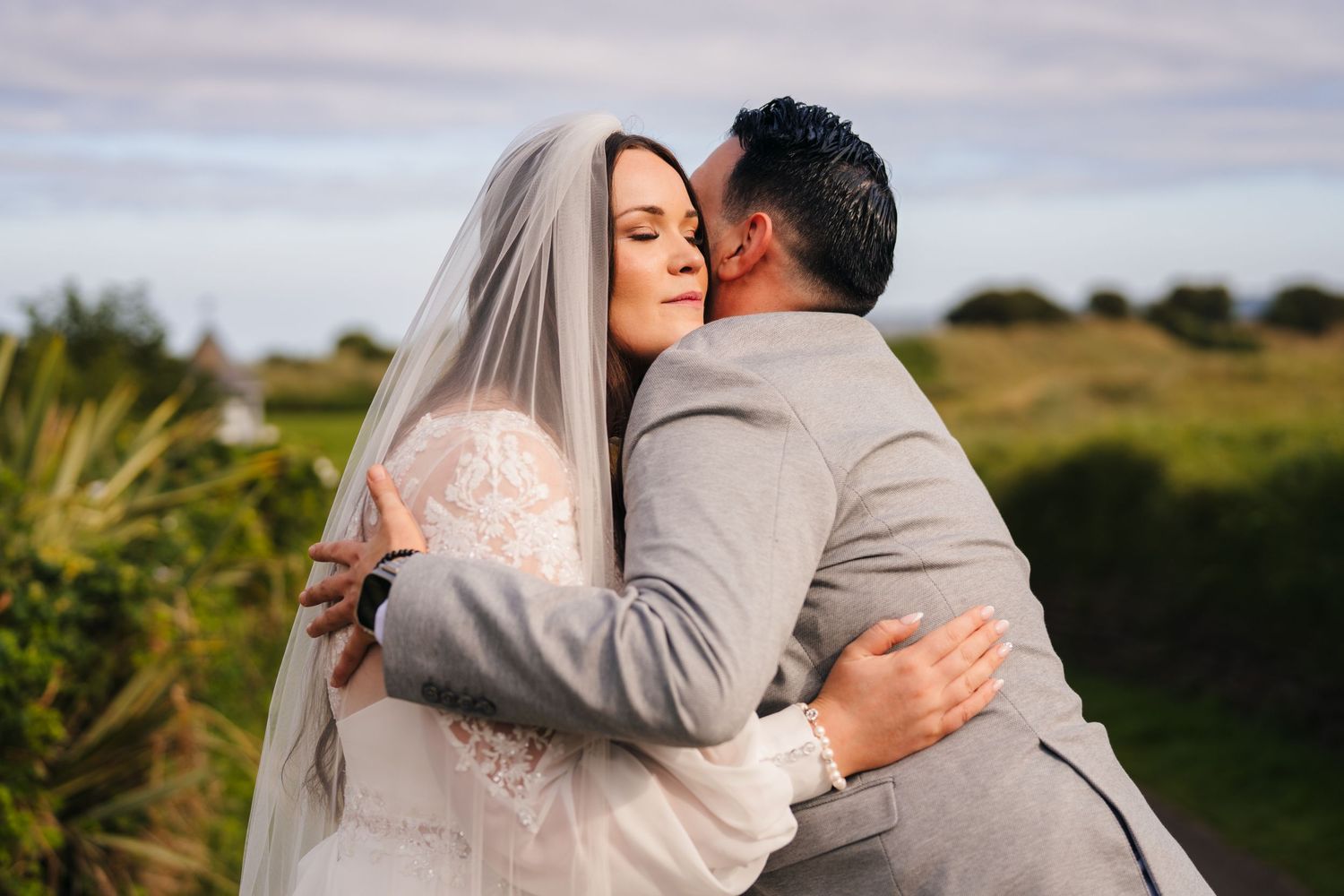 Romantic wedding couple embracing during sunset golden hour photography session. Portmarnock Hotel Wedding PHOTOGRAPHER Dublin
