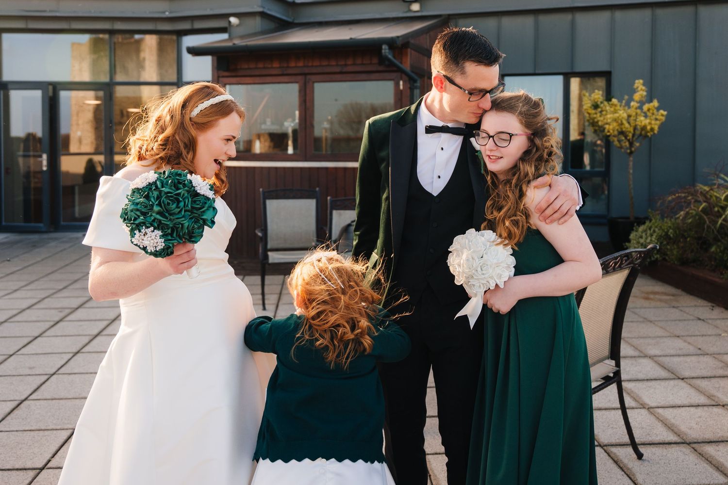 Wedding party posing together outdoors on a paved terrace.  Wedding PHOTOGRAPHER Trim Castle  Wedding PHOTOGRAPHER Trim Castle  Wedding PHOT