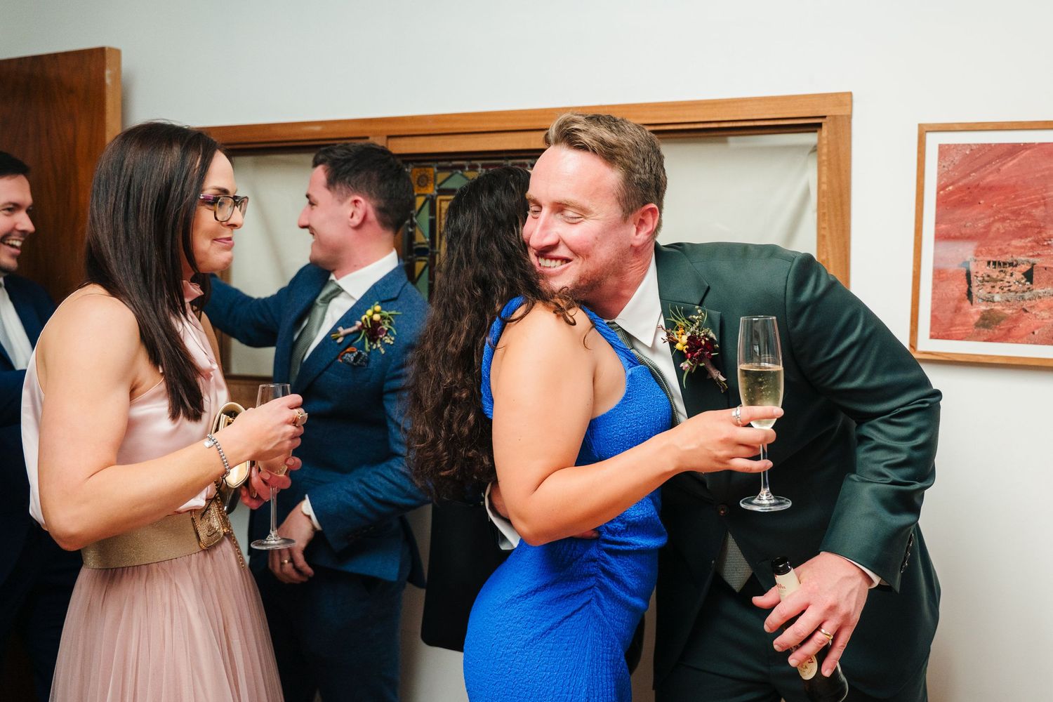 Candid moments of party guests socializing at an indoor event. Same sex wedding PHOTOGRAPHER Dublin