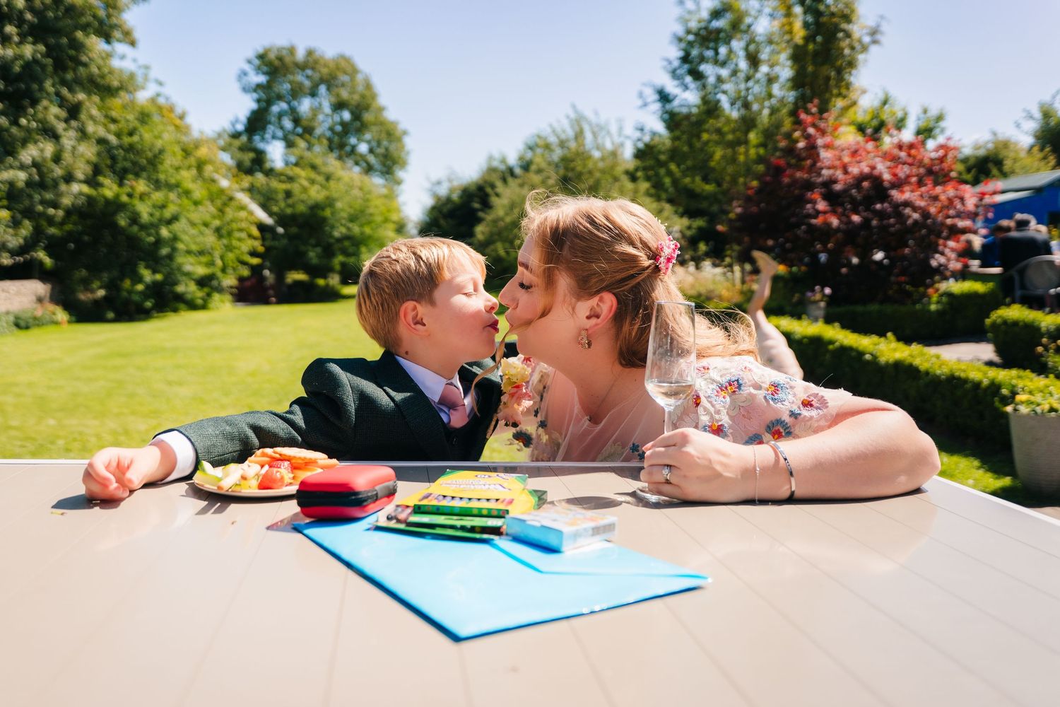 A sweet learning moment outdoors at a picnic table with colorful school supplies. . Village Barn Tyrrellspass wedding photographer Ireland