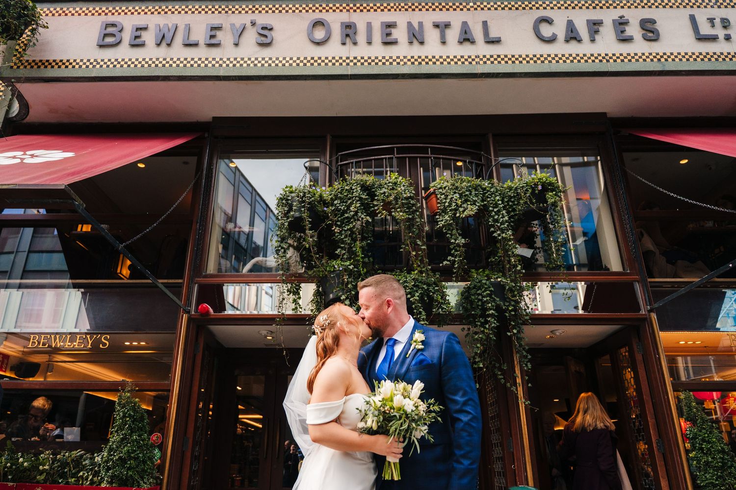Vintage storefront sign reading 'Bewley's Oriental Cafes Ltd' on a brick building facade. Dublin wedding photogrAPher Bewleys Grafton
