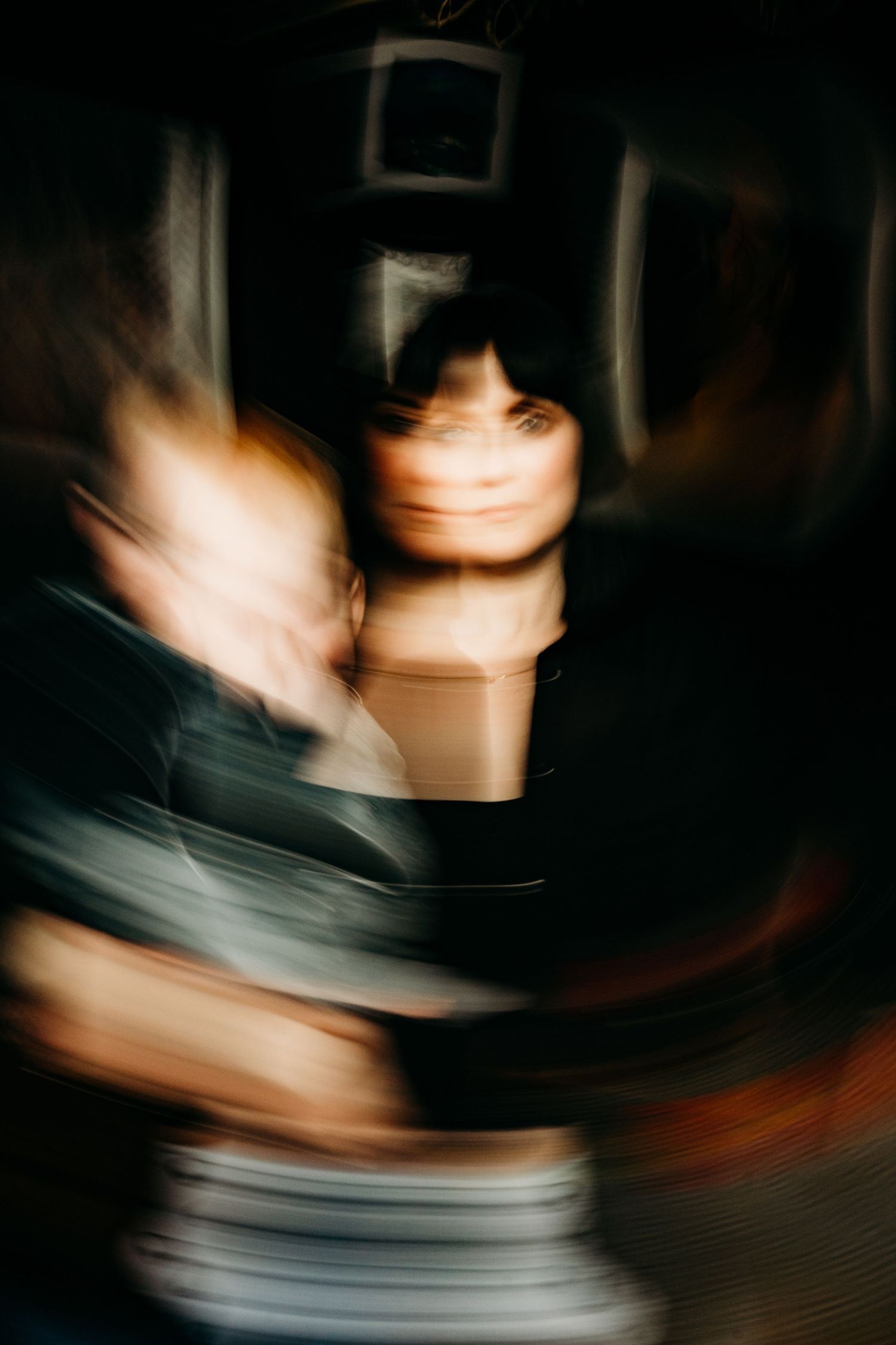 Abstract motion blur portrait creating artistic swirls of light and shadow in dark setting. family PHOTOGRAPHER Dublin
