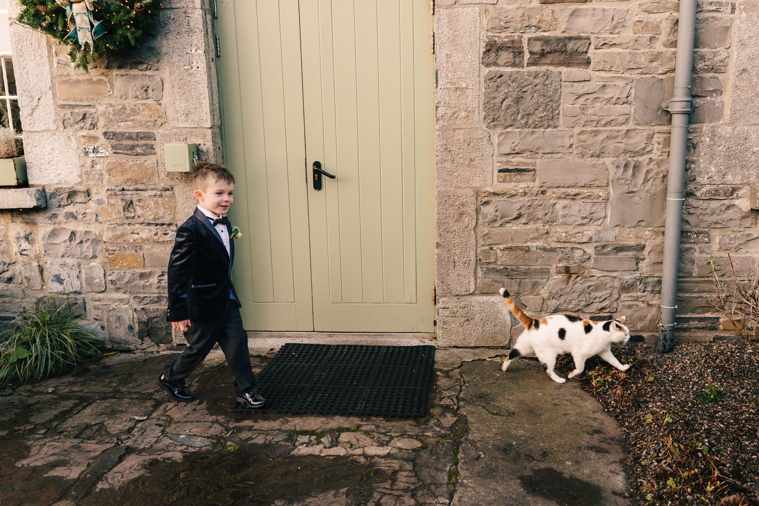 A sequence of five black and white wedding photos arranged horizontally showing romantic moments against stone walls. Ballymagarvey Wedding