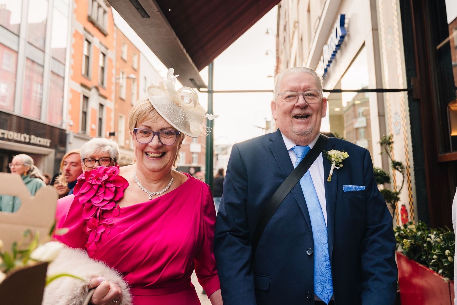 A group of people at a formal event share joyful moments together in an indoor venue. Dublin wedding photogrAPher Bewleys Grafton