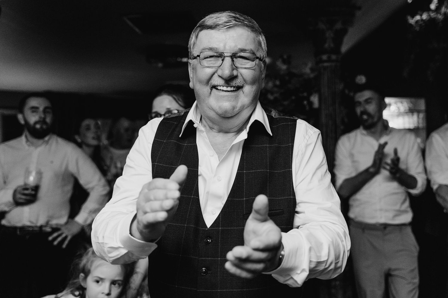 Black and white photo of wedding guests dancing and celebrating together. Marco Pierre Dublin Wedding Photographer