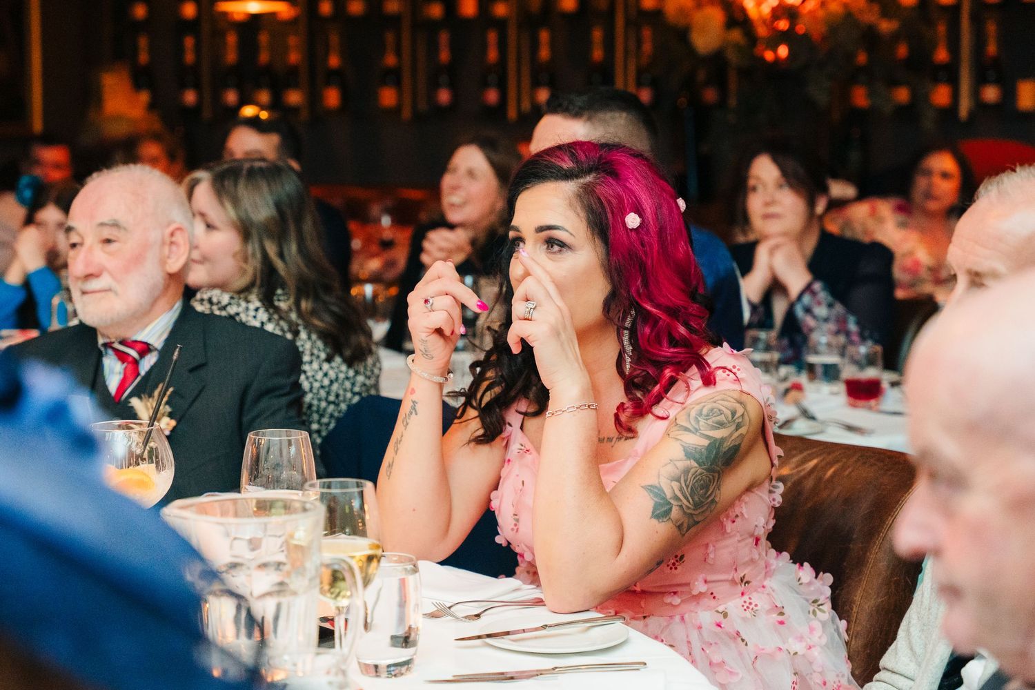 Guests enjoying a festive atmosphere at an evening wedding reception. Marco Pierre Dublin Wedding Photographer