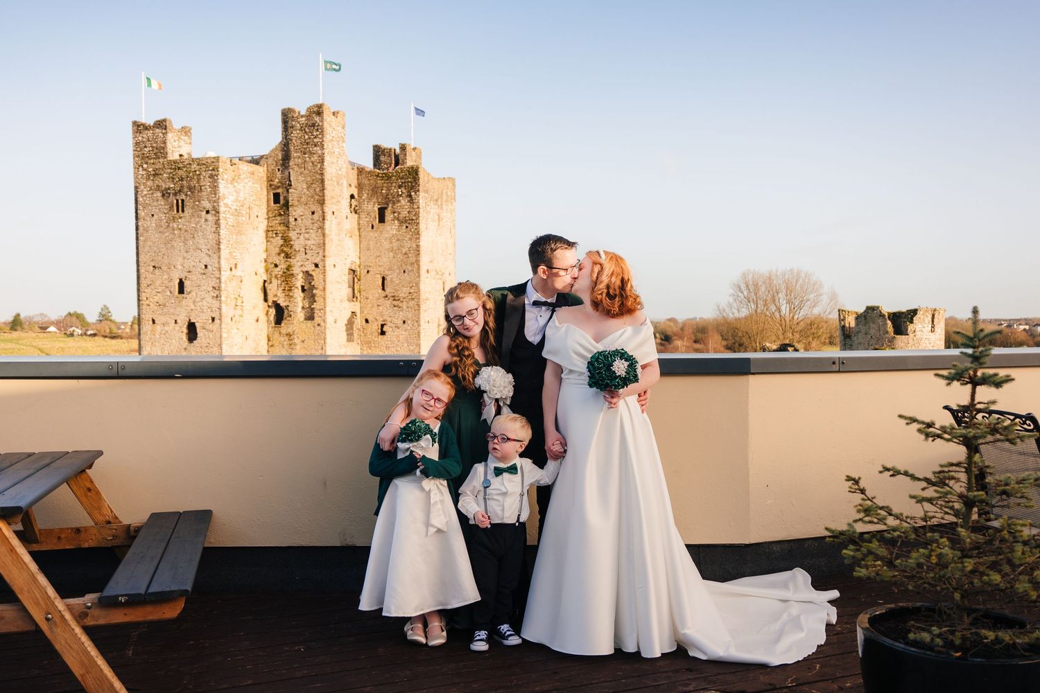 Castle wedding venue with stone towers against a bright blue sky during an outdoor ceremony.  Wedding PHOTOGRAPHER Trim Castle