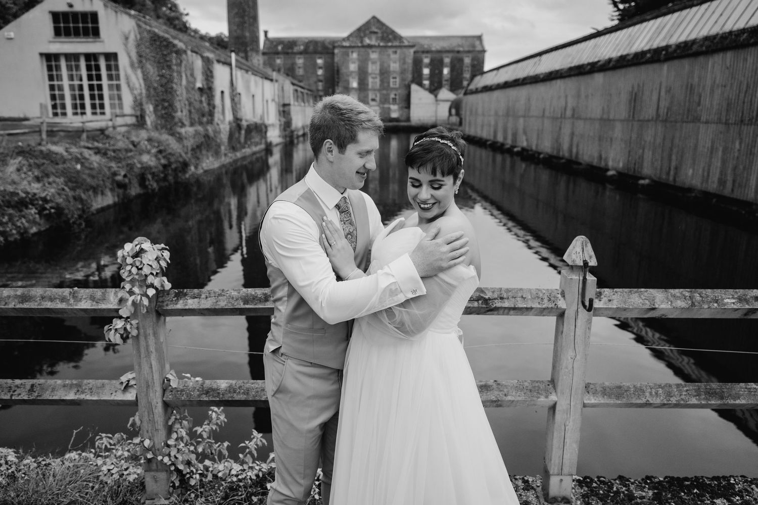 Millhouse slane wedding photographer dublin Black and white photos showing newlyweds sharing intimate moments by a rustic building.