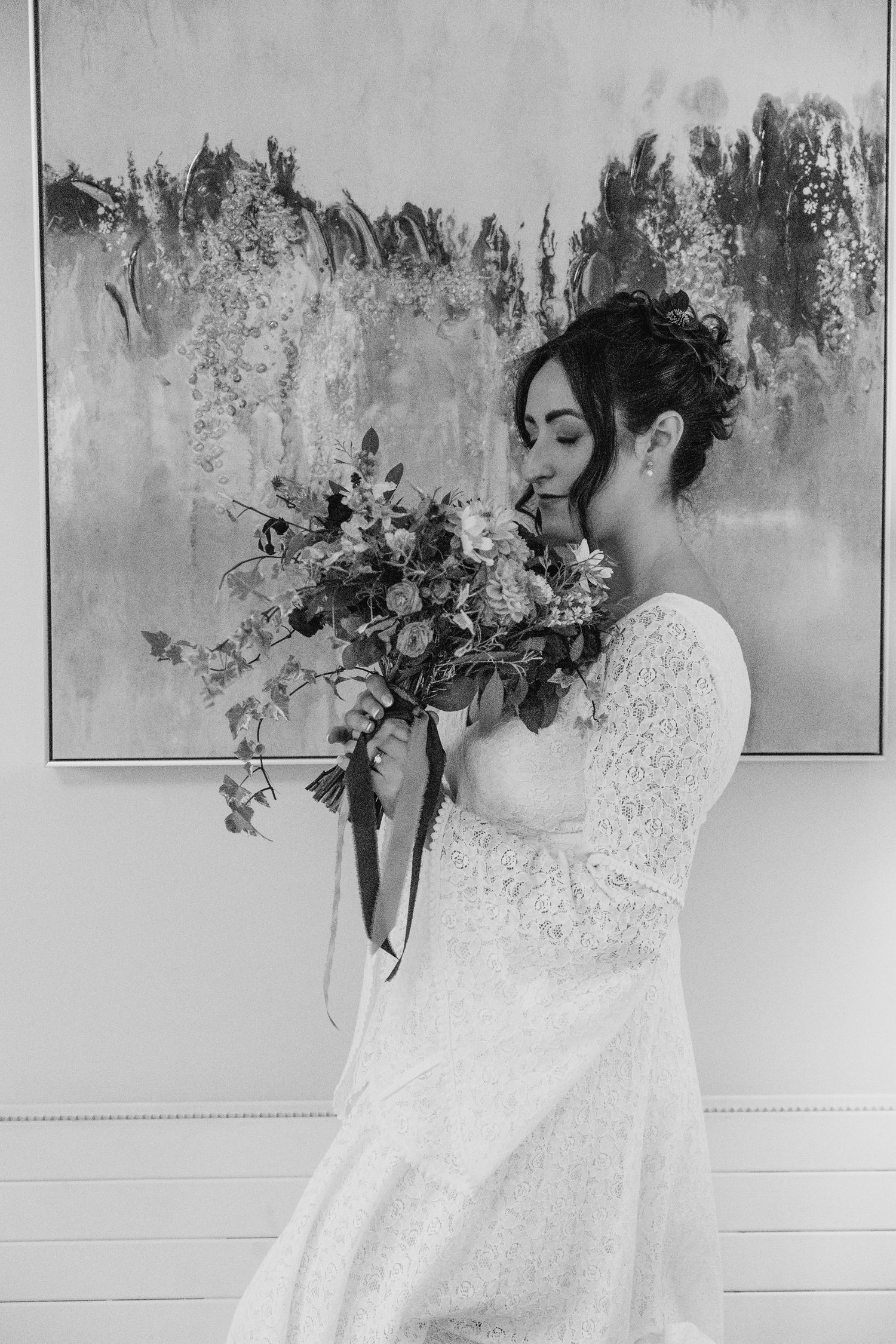 Artistic black and white series showing movement with white lace dress against textured wall.Wedding Photography Trim Castle Ireland