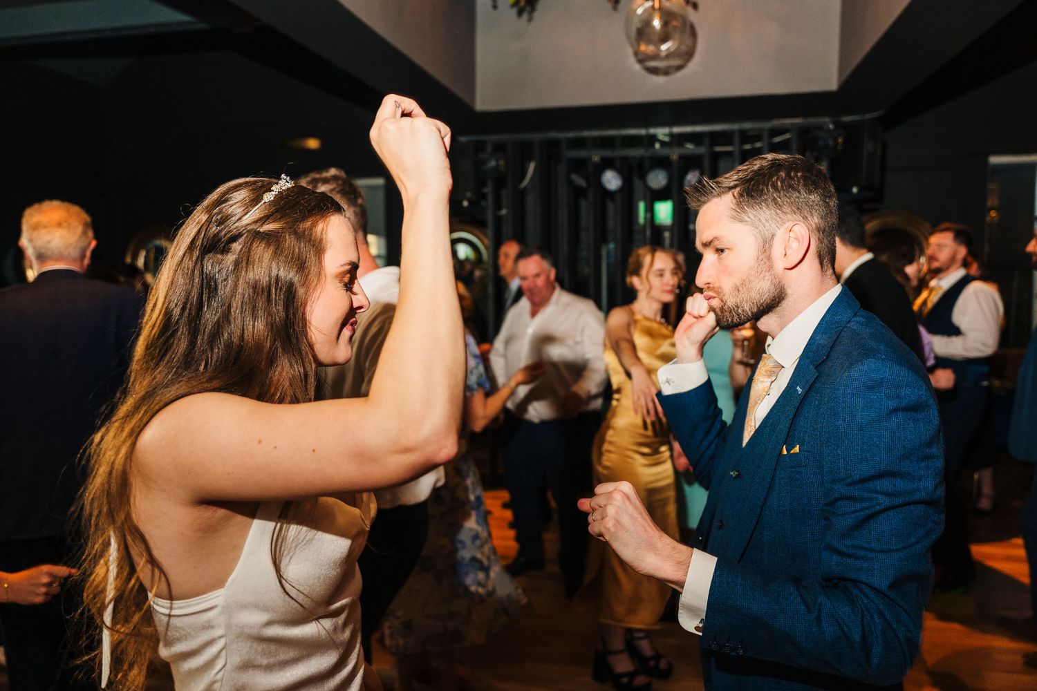 Poulaphouca Wedding photographer wicklow  Energetic dancing and celebration on dark dance floor during wedding reception.