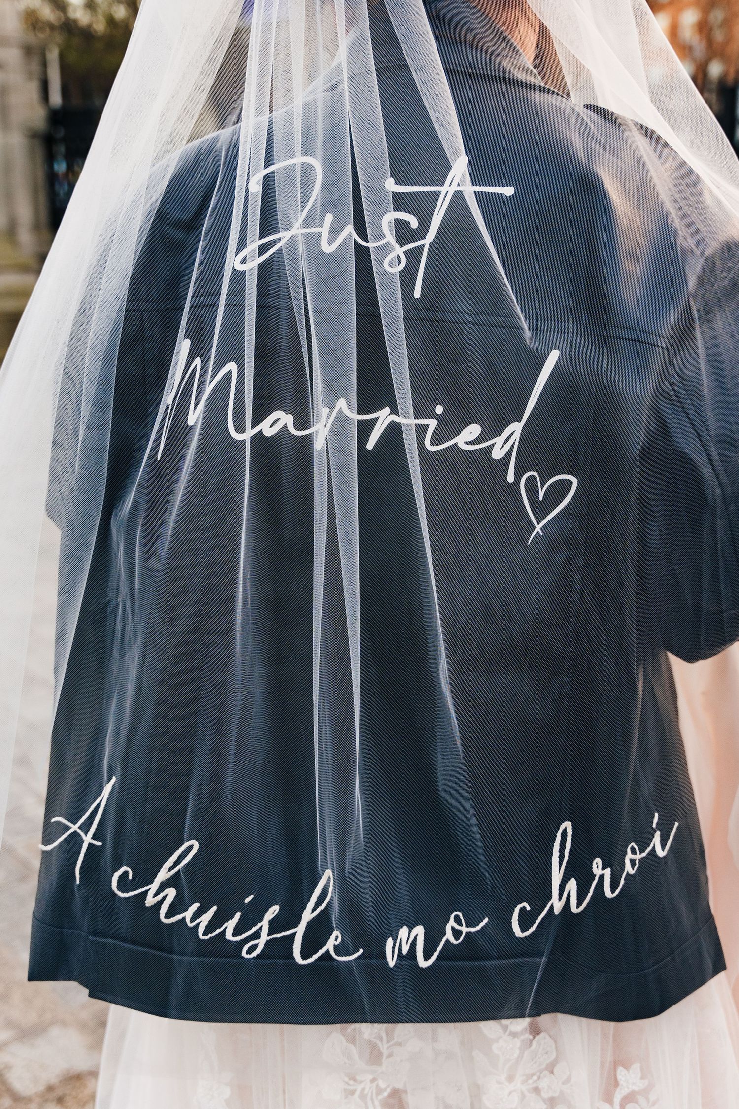 A close-up of a wedding veil with 'Just Married' calligraphy text written on it. Wedding PHOTOGRAPHER Dublin