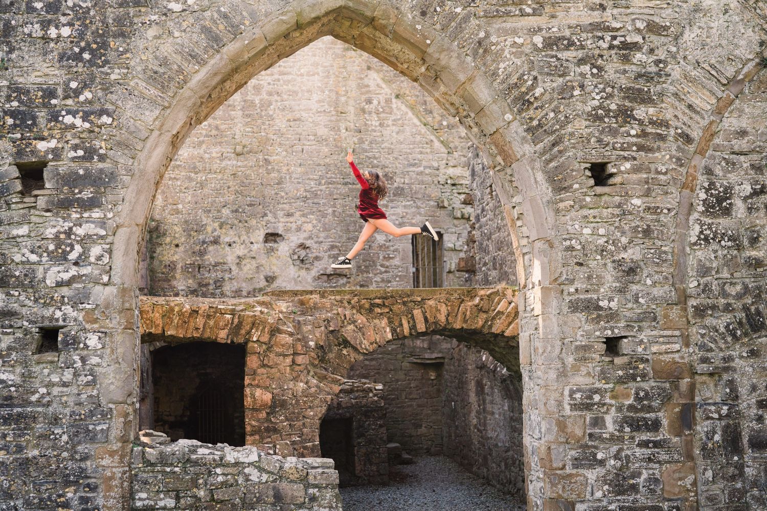 Series of connected stone archways in ancient ruins showing architectural details and weathered walls. Family PHOTOGRAPHER Dublin