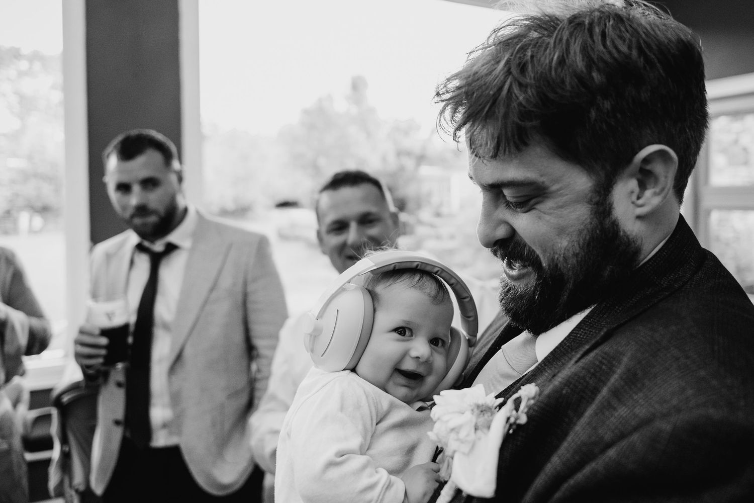 Black and white candid reception photos showing joyful moments and laughter.. Village Barn Tyrrellspass wedding photographer Ireland