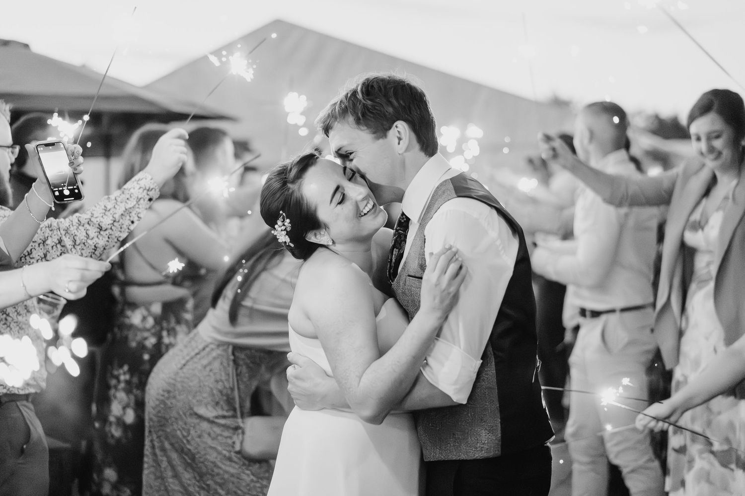 A collection of guests dancing and celebrating at a wedding reception with raised hands and festive energy. Wedding PHOTOGRAPHER Dublin