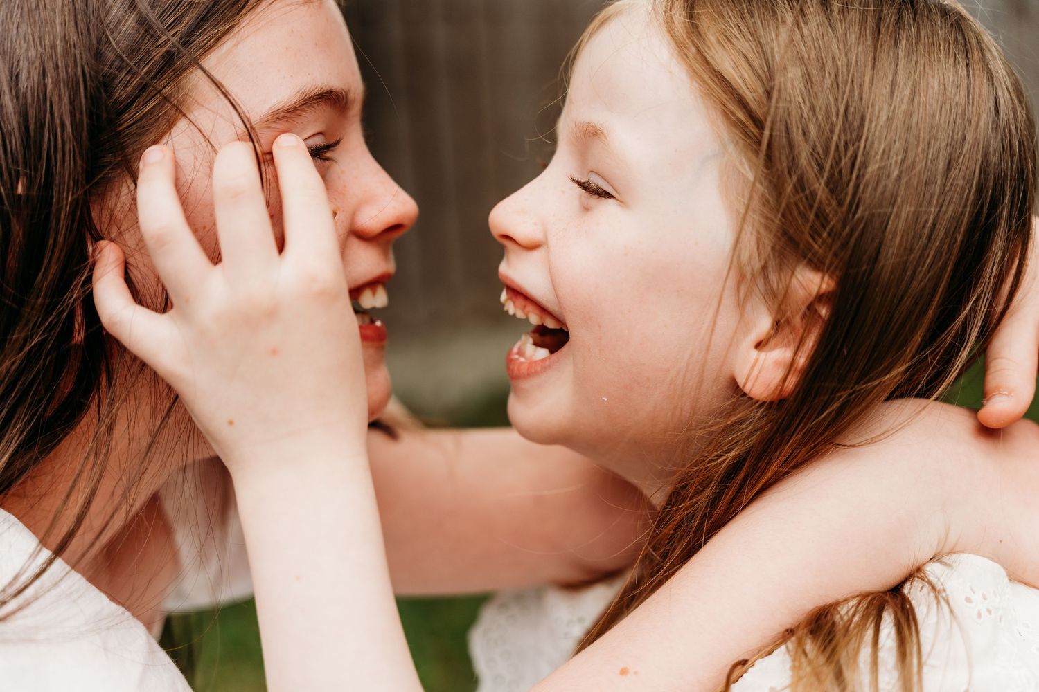 Two people share a joyful close moment together with bright smiles and gentle touches. family PHOTOGRAPHER Dublin