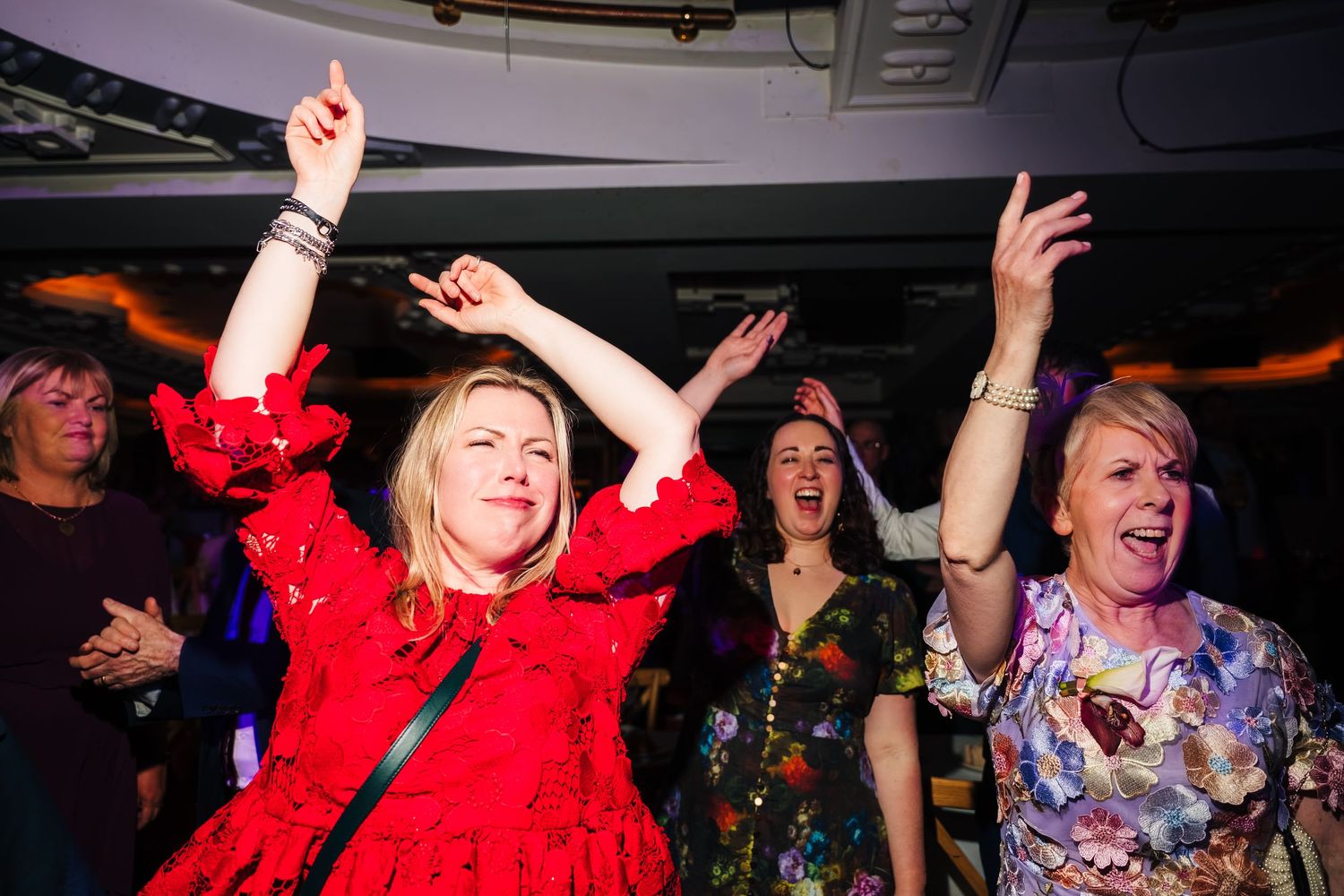 Energetic dance party scene with people in colorful outfits celebrating. Wedding ceremony at the Set Theatre Langtons Hotel Kilkenny