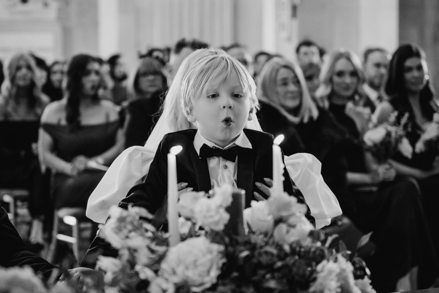 Wedding guests watching ceremony in elegant venue with emotional expressions.Wedding photographer dublin