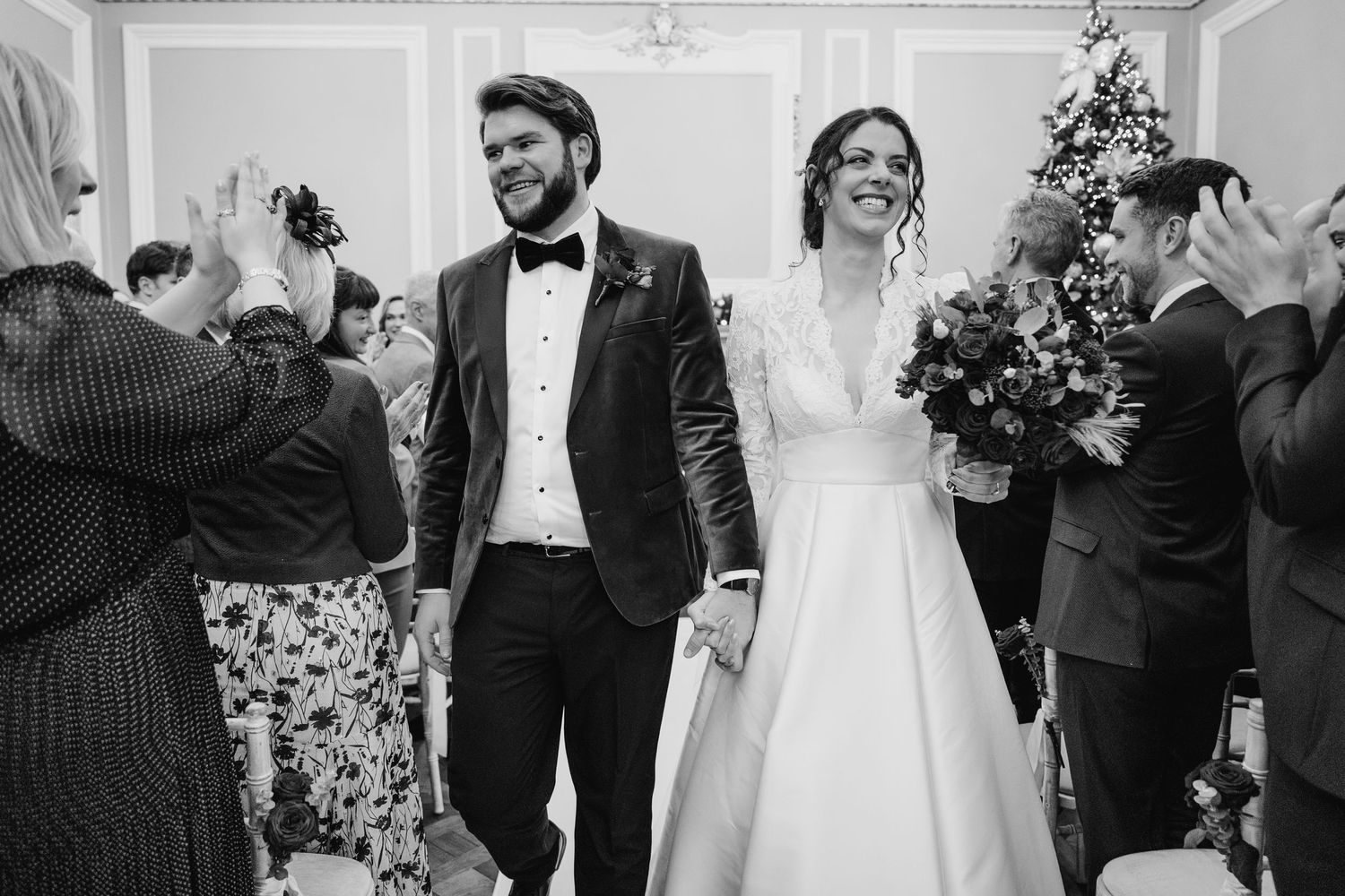 A black and white wedding photo showing newlyweds walking down the aisle Stephens green club dublin Wedding photographer
