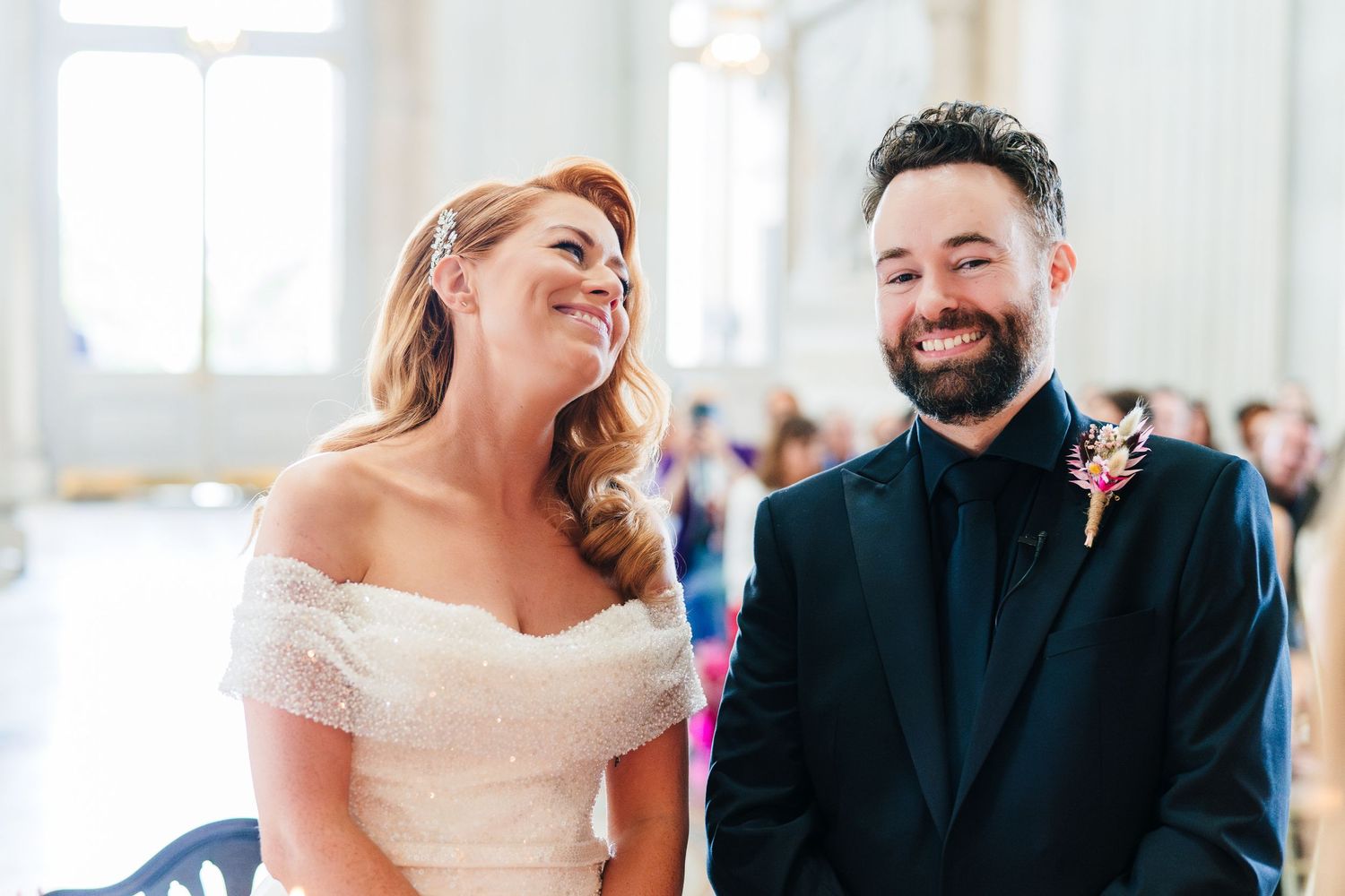Candid wedding ceremony moments captured in a bright indoor venue with natural light.  city hall dublin wedding photos