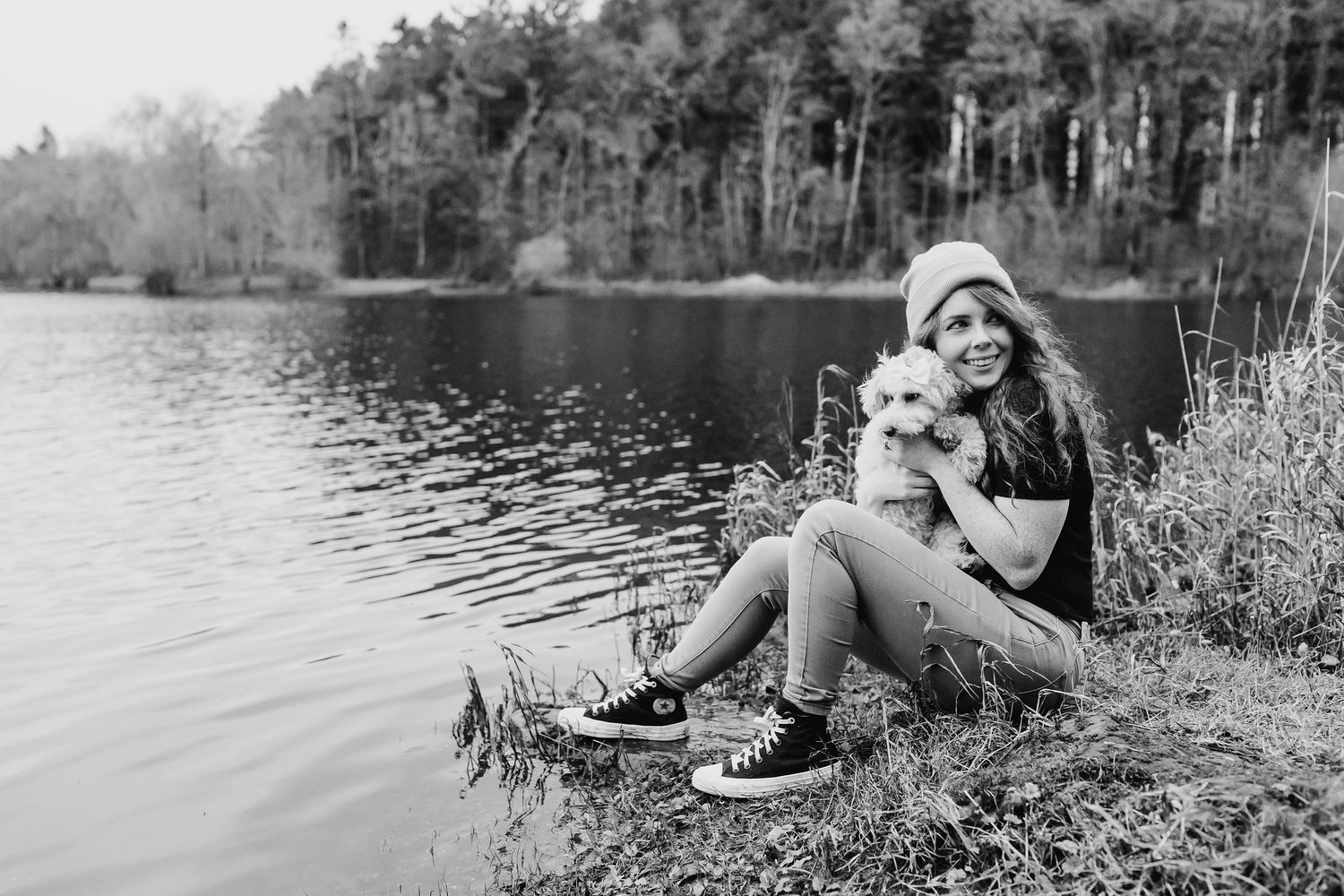 A person lounges by a serene lake on a sunny day, surrounded by natural scenery and Dublin Professional headshots PHOTOGRAPHER