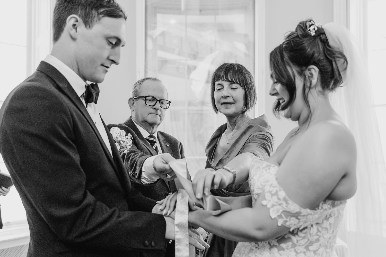 Black and white photo of an emotional moment during a wedding ring exchange ceremony at a wedding.  Wedding PHOTOGRAPHER Dublin