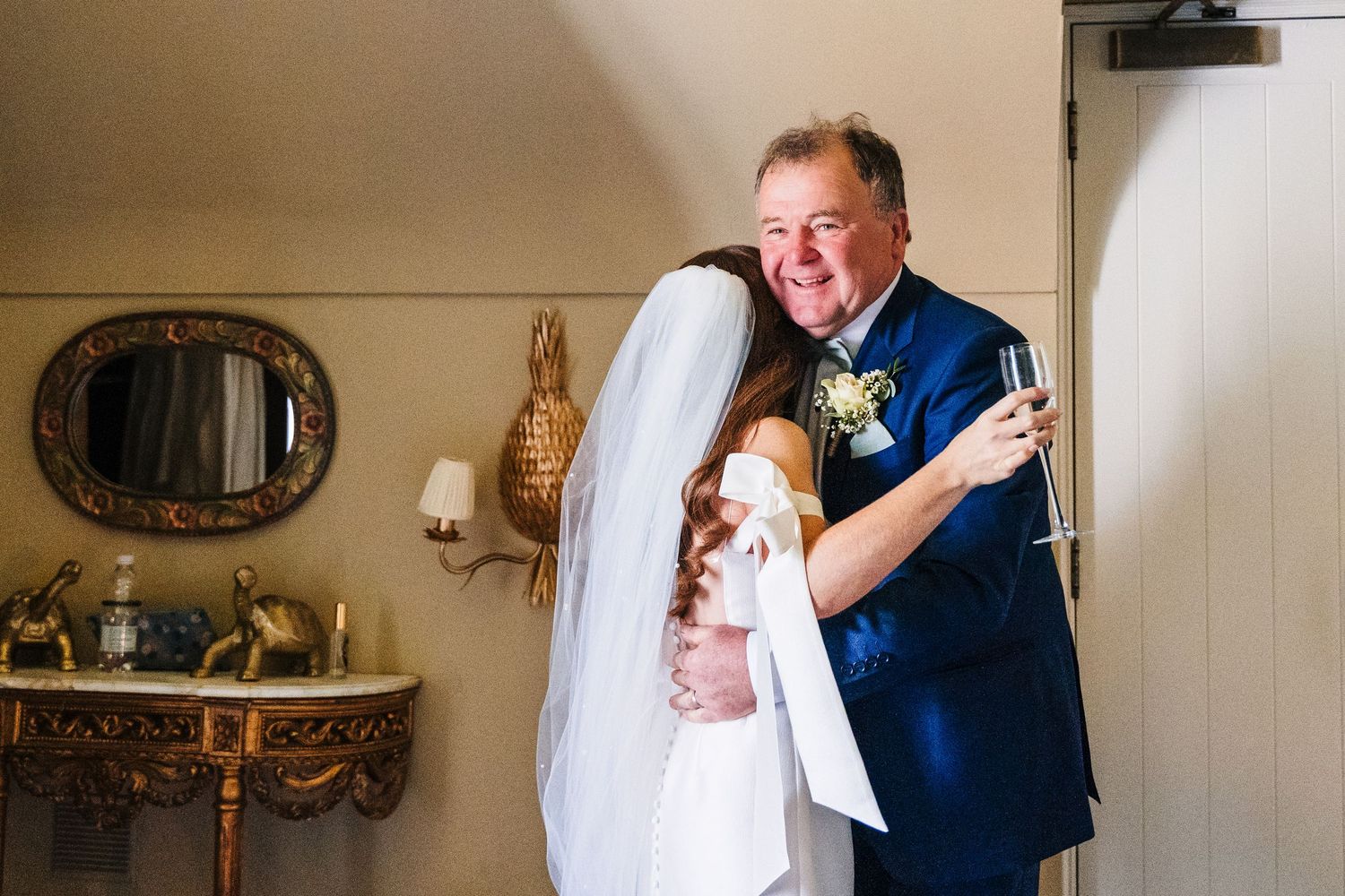 Castle Leslie Wedding Photographer Dublin An emotional moment between a bride and someone in a navy suit during a wedding celebration.