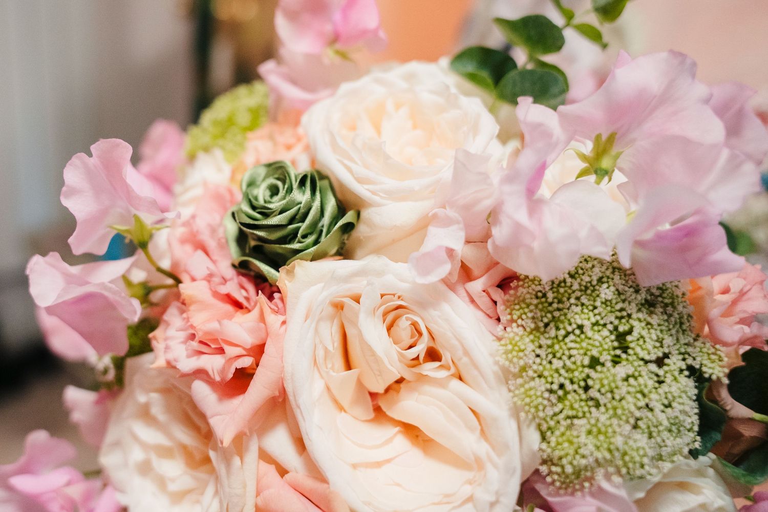 Elegant pink and peach wedding bouquets with roses and delicate flowers arranged in soft pastel colors. . Village Barn Tyrrellspass wedding